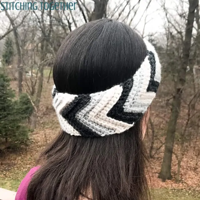woman wearing striped crochet chevron ear warmer