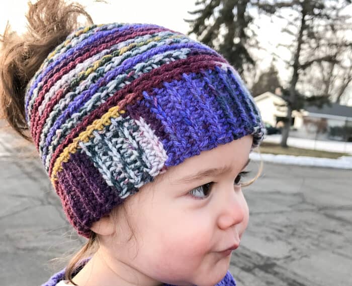 toddler girl wearing a multicolored crochet toddler hat