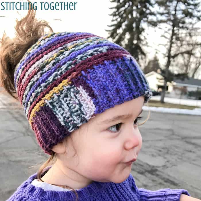 toddler girl wearing a multicolored crochet toddler hat