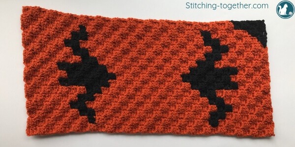orange crochet rectangle with 2 black bats