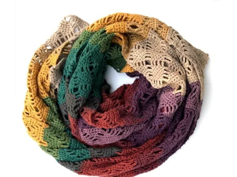 Free pattern to make this gorgeous crochet wrap. Simple to make and works as a cozy scarf. Made in Mandala Yarn the colors make the perfect shawl for fall.