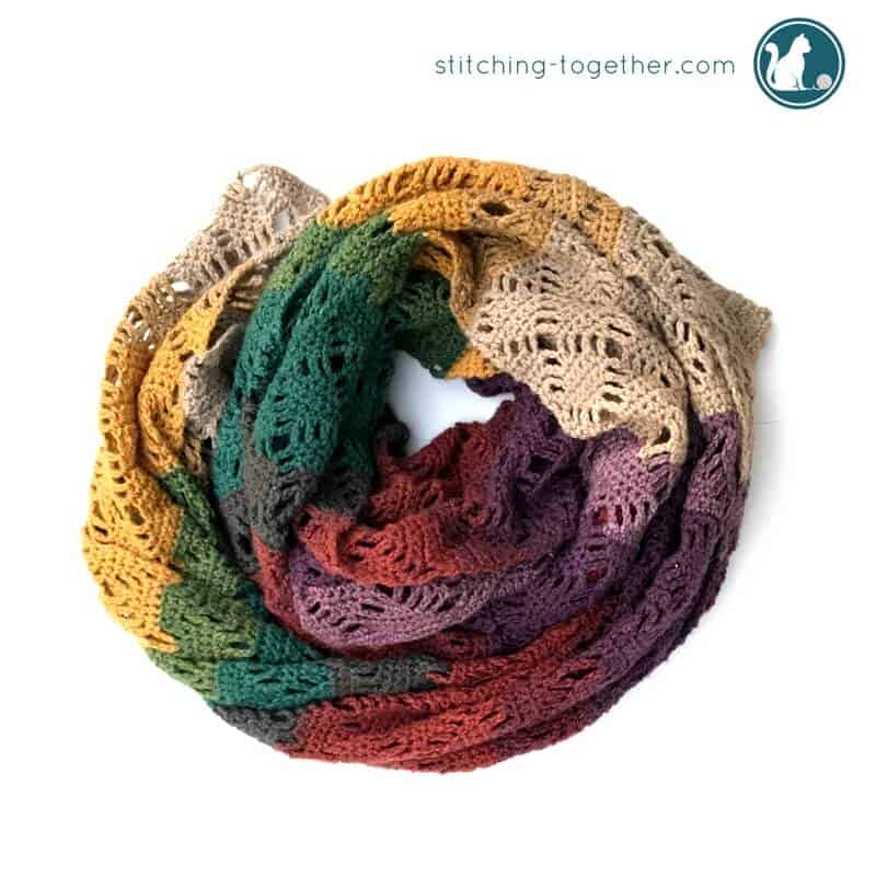 Free pattern to make this gorgeous crochet wrap. Simple to make and works as a cozy scarf. Made in Mandala Yarn the colors make the perfect shawl for fall.