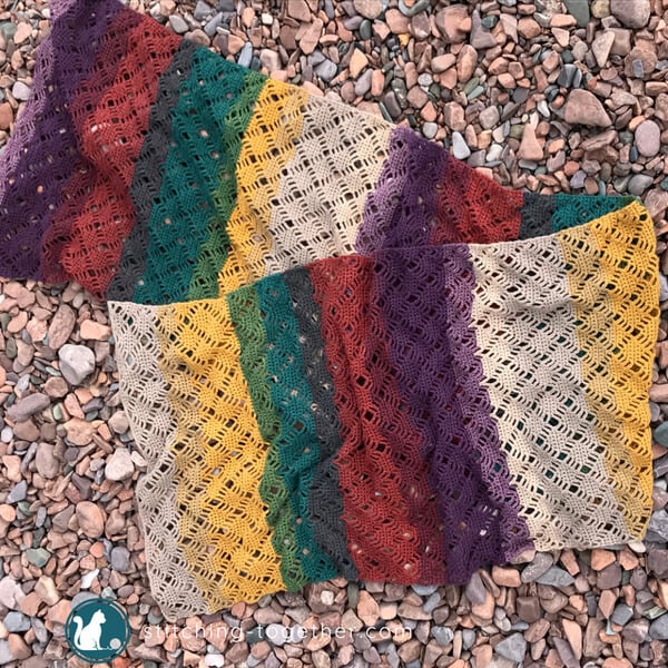 multi colored crochet scarf on ground