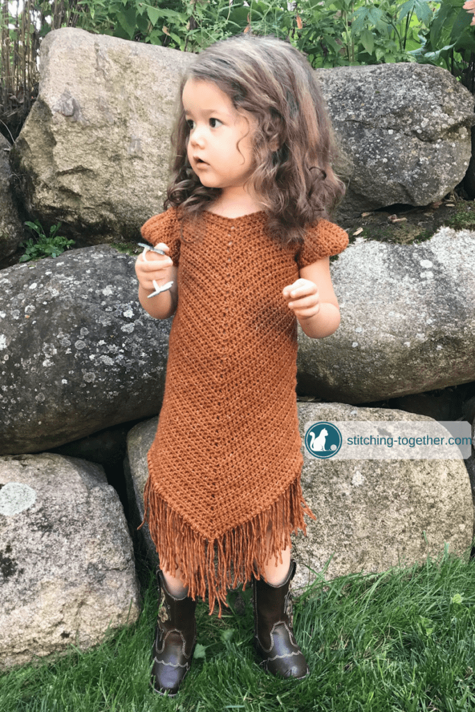 Free pattern for an easy crochet toddler dress. Even if you are a beginner crocheter, you can make this dress for the little girls in your life. The beautiful suede look is achieved with Lion Brand Jeans yarn in top stitch. 