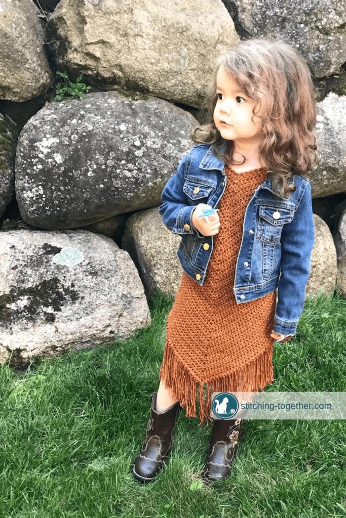 Free pattern for an easy crochet toddler dress. Even if you are a beginner crocheter, you can make this dress for the little girls in your life. The beautiful suede look is achieved with Lion Brand Jeans yarn in top stitch. 