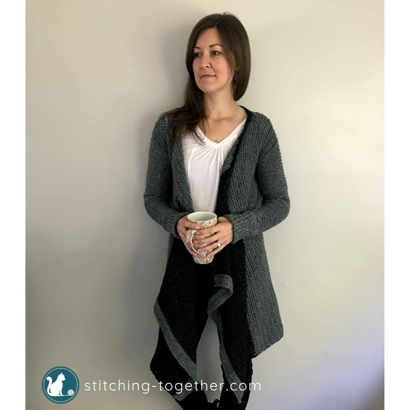 gal wearing crochet blanket cardigan holding mug