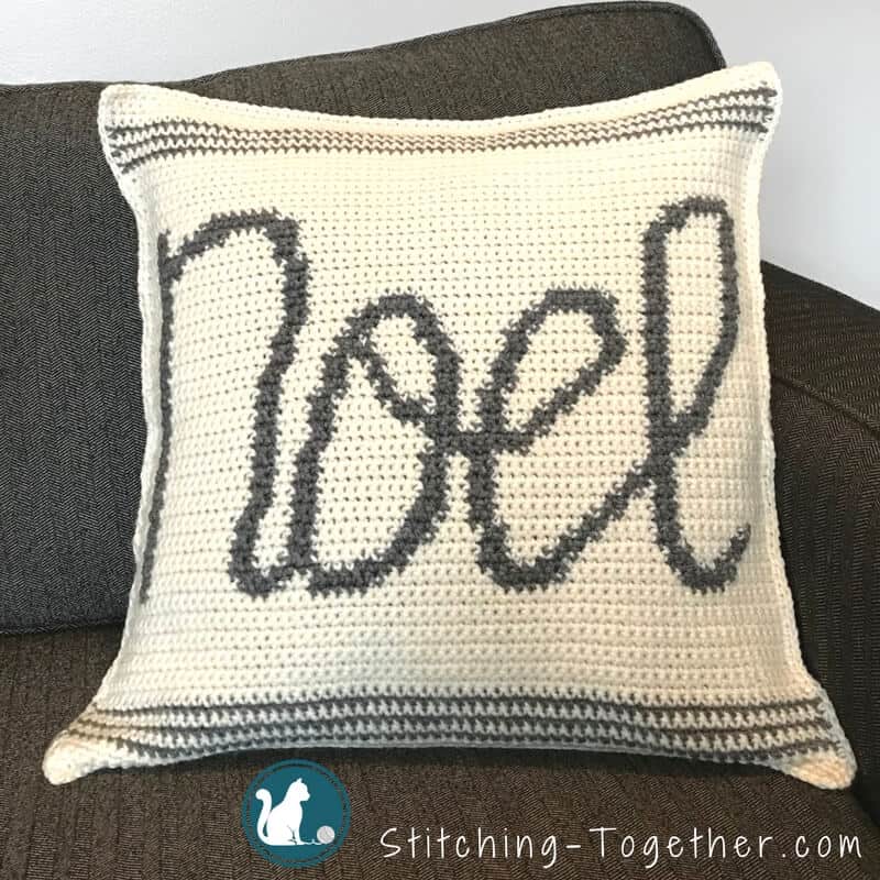 Crochet cushion cover will the word Noel across the front 