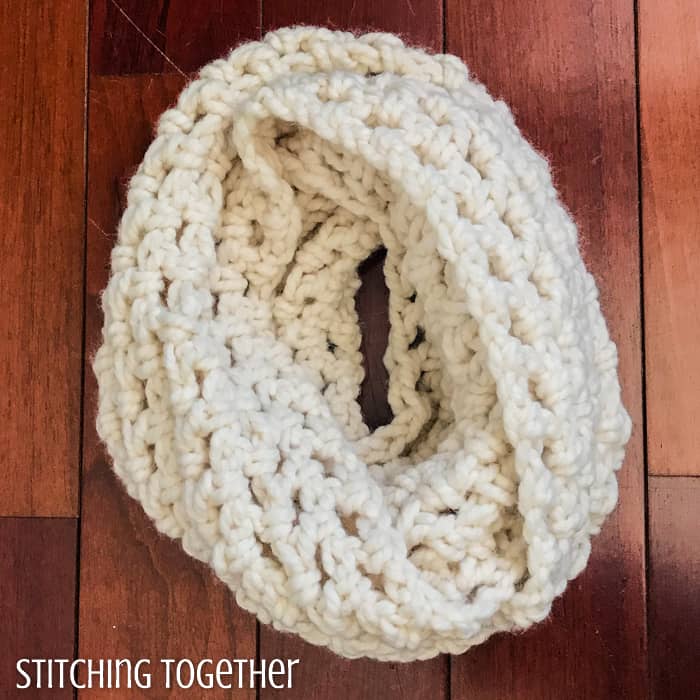 quick and easy crochet infinity scarf lying on the ground