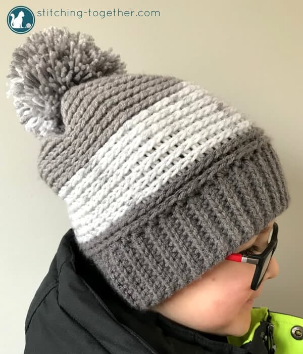 Chec out this free pattern for a crochet slouchy hat perfect for kids! Super easy to make slouchy beanie extra fun in Premier Yarn Sweet Rolls. The pom pom adds the perfect touch! 