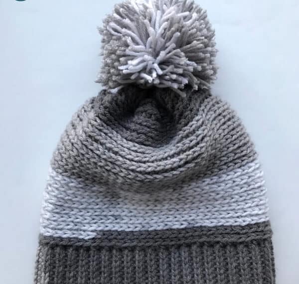 Check out this free pattern for a crochet slouchy hat perfect for kids! Super easy to make slouchy beanie extra fun in Premier Yarn Sweet Rolls. The pom pom adds the perfect touch!
