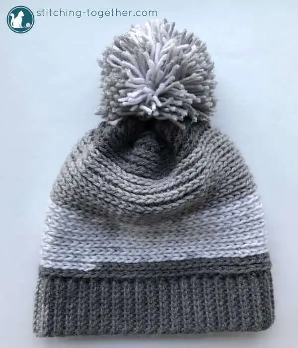 Chec out this free pattern for a crochet slouchy hat perfect for kids! Super easy to make slouchy beanie extra fun in Premier Yarn Sweet Rolls. The pom pom adds the perfect touch! 