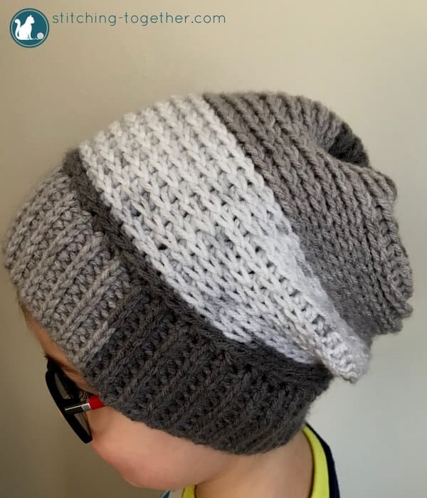 Chec out this free pattern for a crochet slouchy hat perfect for kids! Super easy to make slouchy beanie extra fun in Premier Yarn Sweet Rolls. The pom pom adds the perfect touch! 