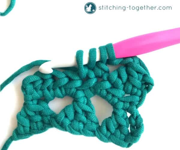 Learn how to crochet the Modified Cluster stitch with this full photo tutorial. The stitch creates adorable triangles which are great for scarves or accessories. 