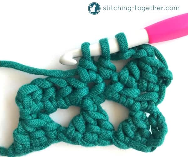 Learn how to crochet the Modified Cluster stitch with this full photo tutorial. The stitch creates adorable triangles which are great for scarves or accessories. 