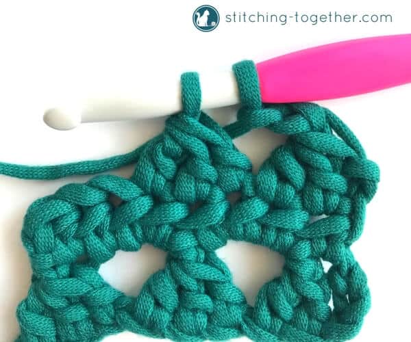 Learn how to crochet the Modified Cluster stitch with this full photo tutorial. The stitch creates adorable triangles which are great for scarves or accessories. 