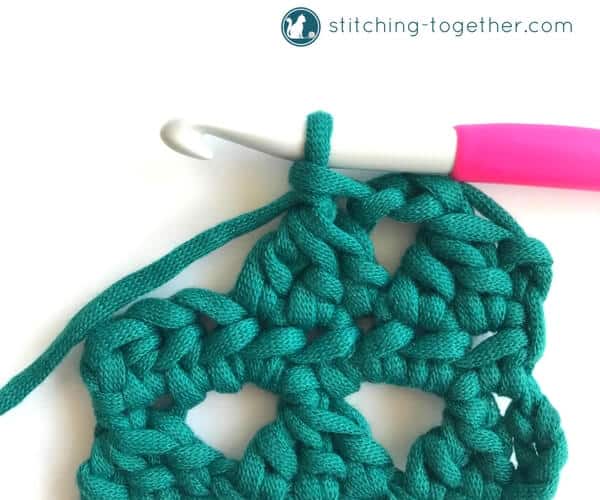 Learn how to crochet the Modified Cluster stitch with this full photo tutorial. The stitch creates adorable triangles which are great for scarves or accessories. 