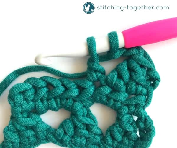 Learn how to crochet the Modified Cluster stitch with this full photo tutorial. The stitch creates adorable triangles which are great for scarves or accessories. 