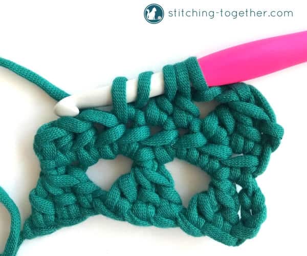 Learn how to crochet the Modified Cluster stitch with this full photo tutorial. The stitch creates adorable triangles which are great for scarves or accessories. 