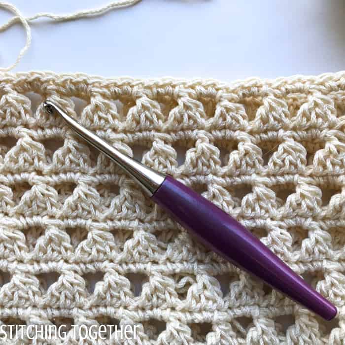 close up of modified cluster stitches and furls crochet hook