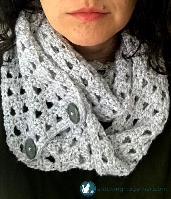 close up of woman wearing a crochet scarf