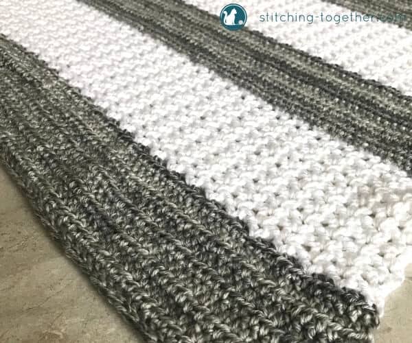 gray and white striped crochet v stitch blanket