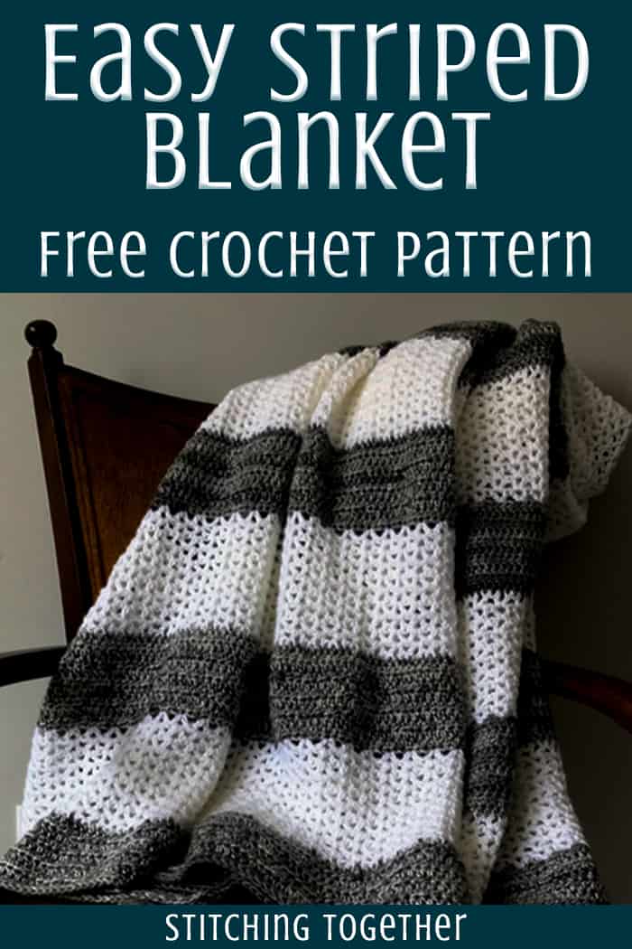 gray and white crochet throw blanket draped on a chair