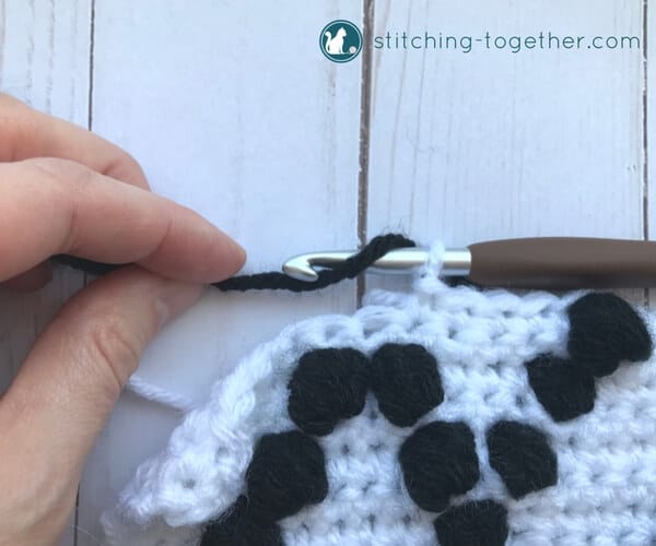 starting a black bobble stitch on a white background