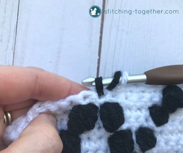 starting a black bobble stitch on a white background