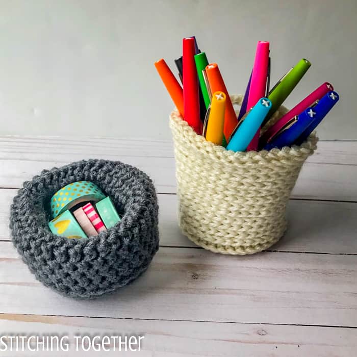 2 mini crochet baskets one with tape and one with pens inside