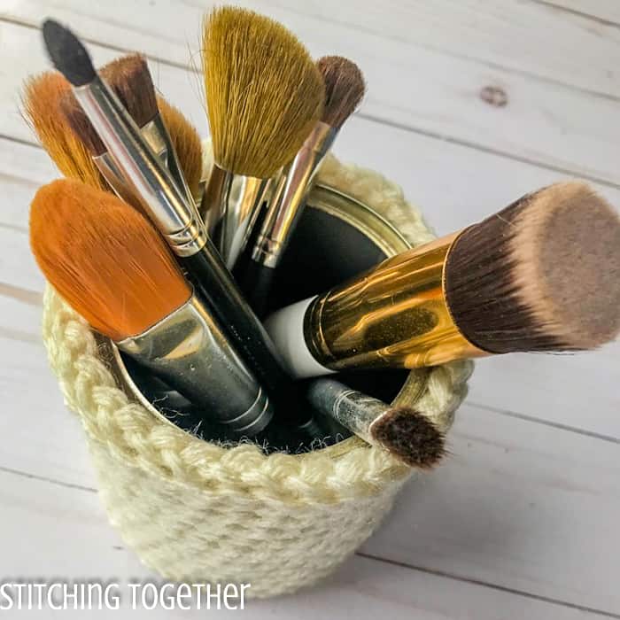 make up brushes inside a crochet basket