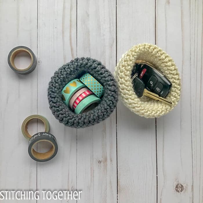 two mini crochet baskets with key and tape insde
