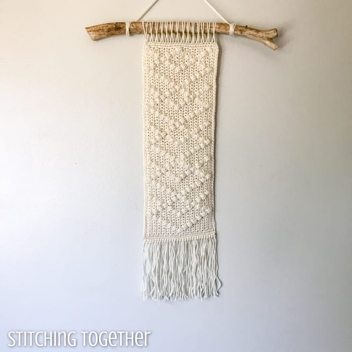 crochet wall hanging on a stick