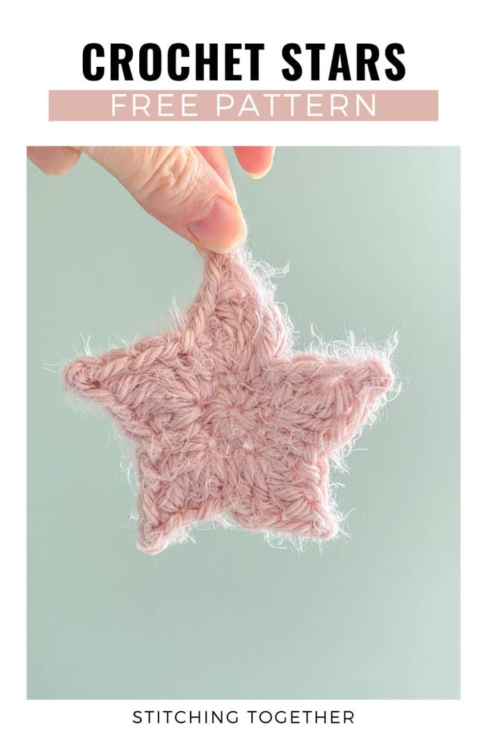 pink star being held up in front of a greenish background