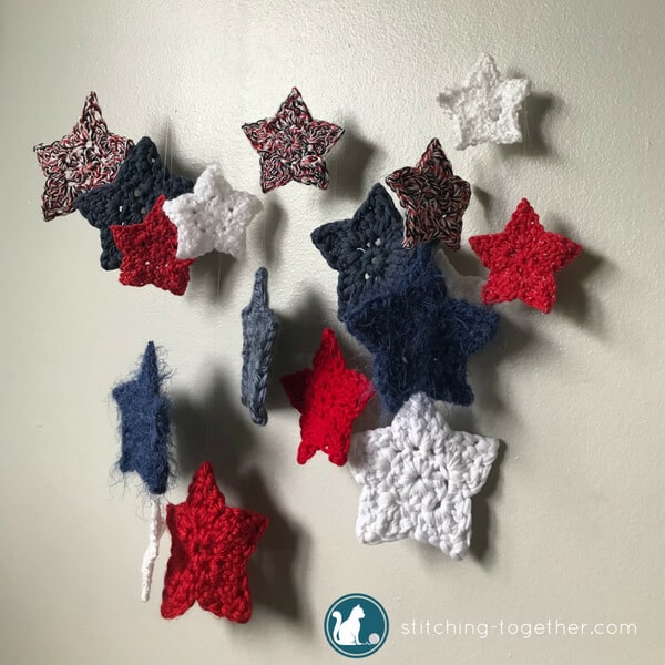 DIY this adorable crochet stars wall hanging! Using scrap yarn stars, invisible thread, and a tree branch, you can create this perfect holiday decoration. Make it red, white and blue for the 4th of July or red and green for Christmas. The possibilities ae endless with this fun and quick weekend project.