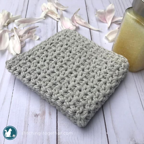 crochet spa washcloth with flower petals and scrub