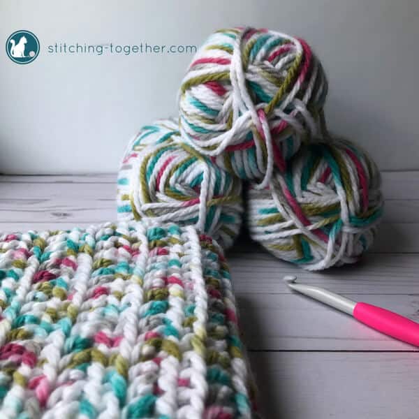 view of baby blanket, crochet hook, and sprinkles yarn