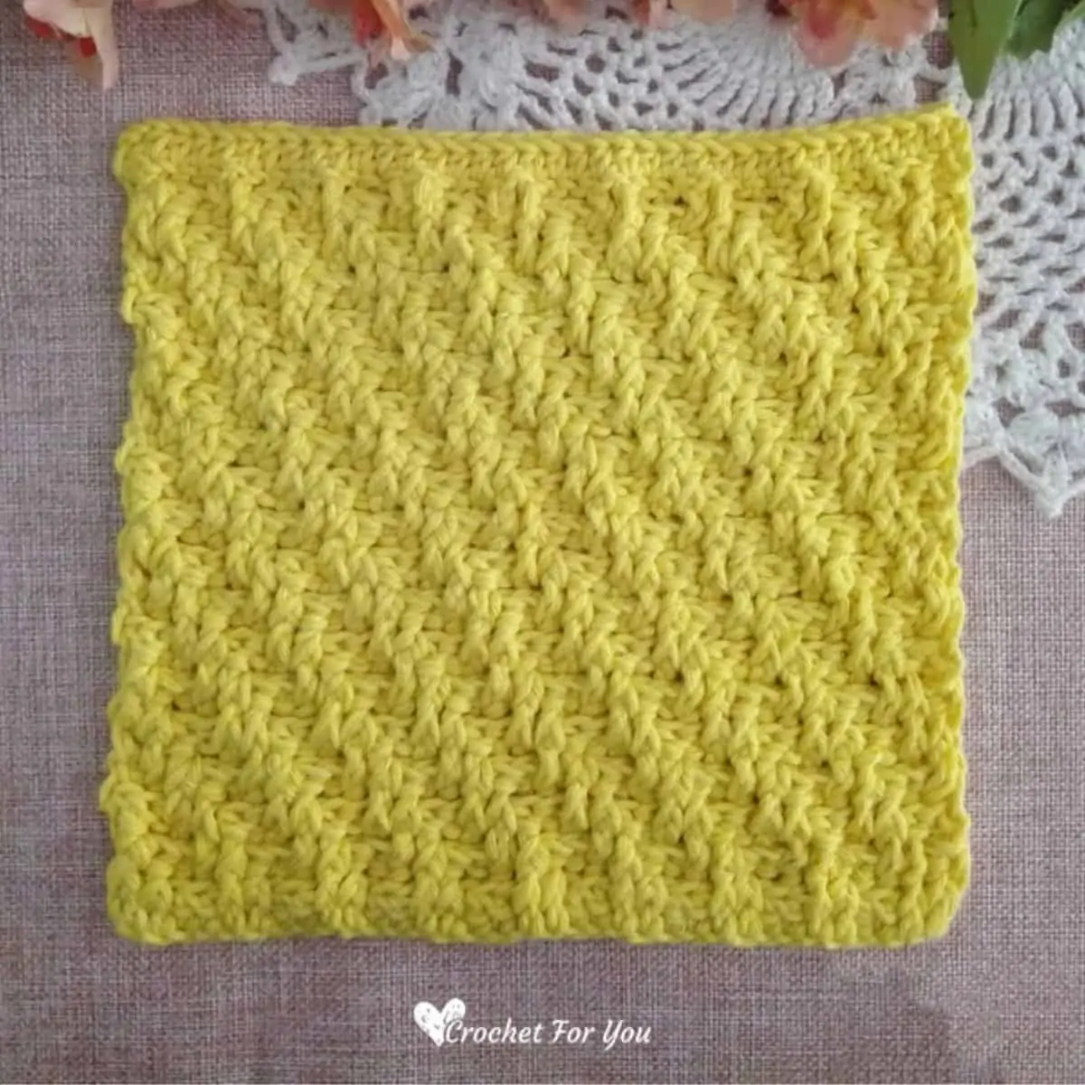 yellow crochet square dishcloth with raised stitches
