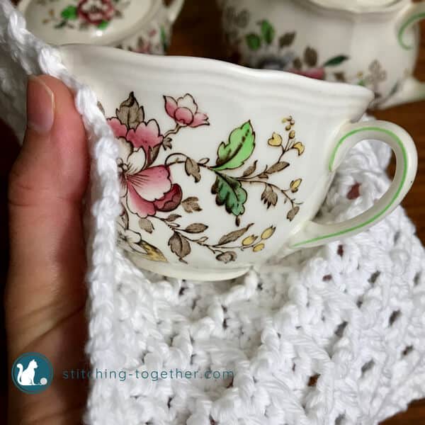 crochet waffle stitch dishcloth wrapped around a teacup