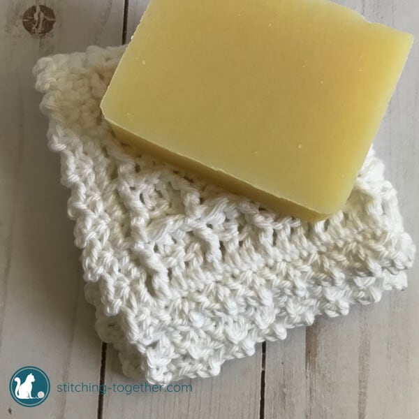 crochet Waffle stitch washcloth with a bar of soap on top