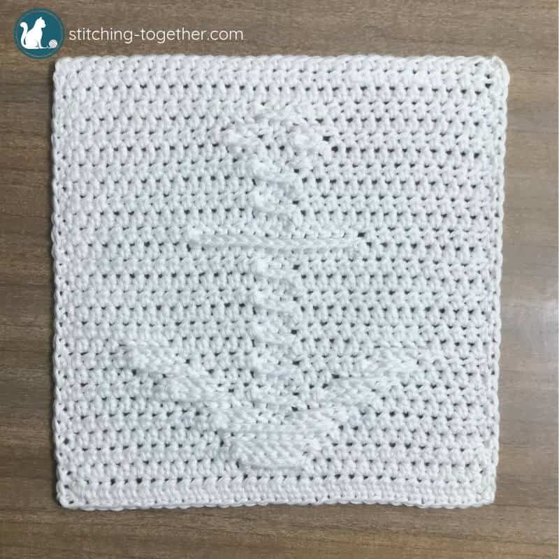 white crochet square with anchor motif