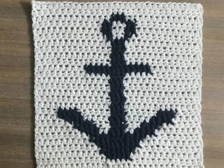 white crochet square with blue anchor pattern
