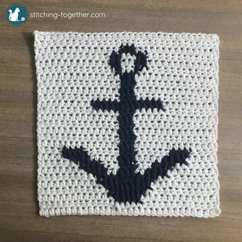 white crochet square with blue anchor pattern