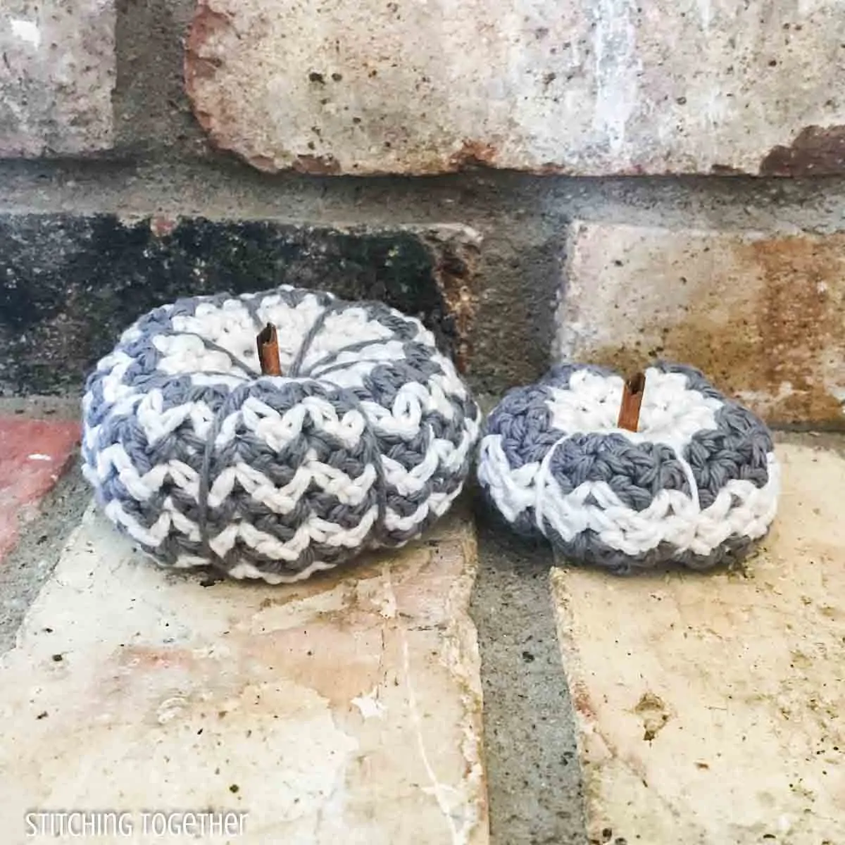 2 striped crochet pumpkins on brick