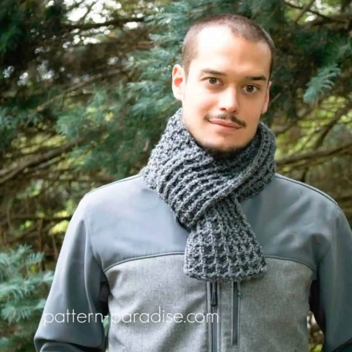 man wearing a gray crochet scarf