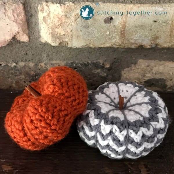 Orange crochet pumpkin and gray and white crochet pumpkin