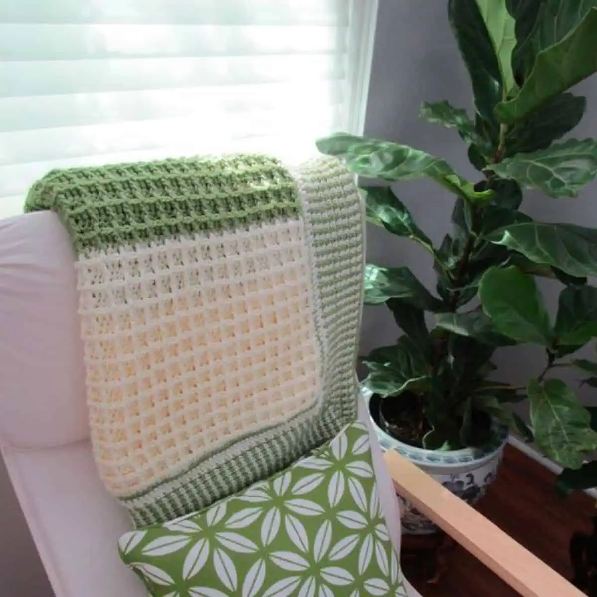 crochet blanket draped on the back of a chair