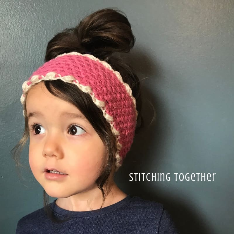 young girl wearing pink crochet ear warmer