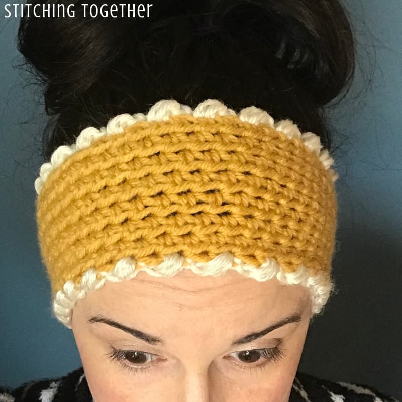 adult wearing yellow crochet ear warmer