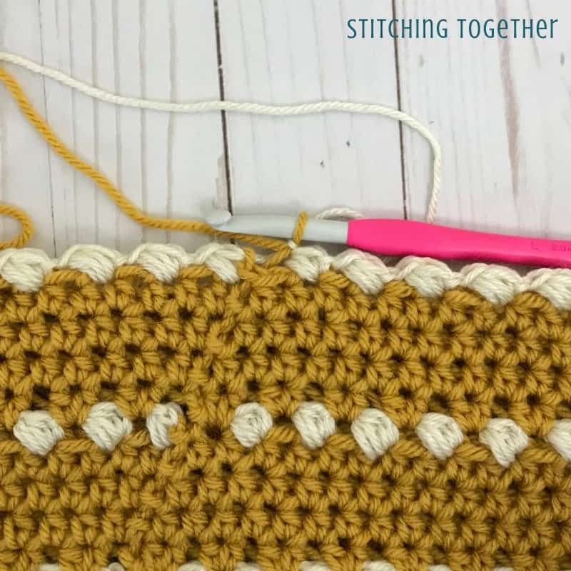 yellow crochet stitches with ivory puff stitches
