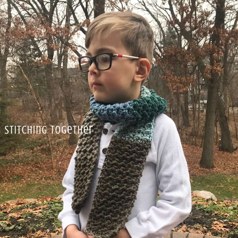 boy wearing a brown and blue crochet scarf for children